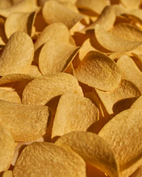 Close-up of spicy chips with chili flakes and electric blue background.