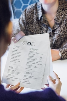 person holding white printer paper