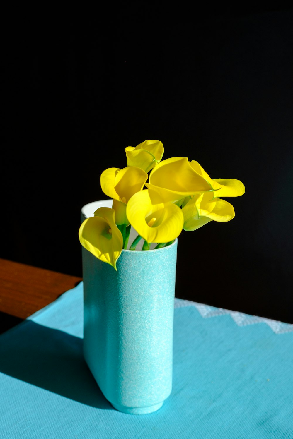 yellow flower in green vase