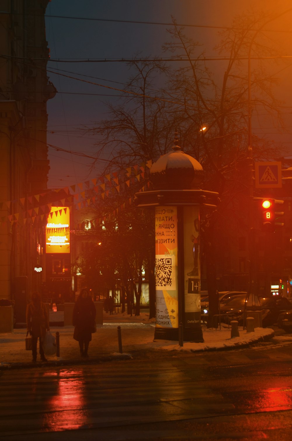 people walking on sidewalk during night time