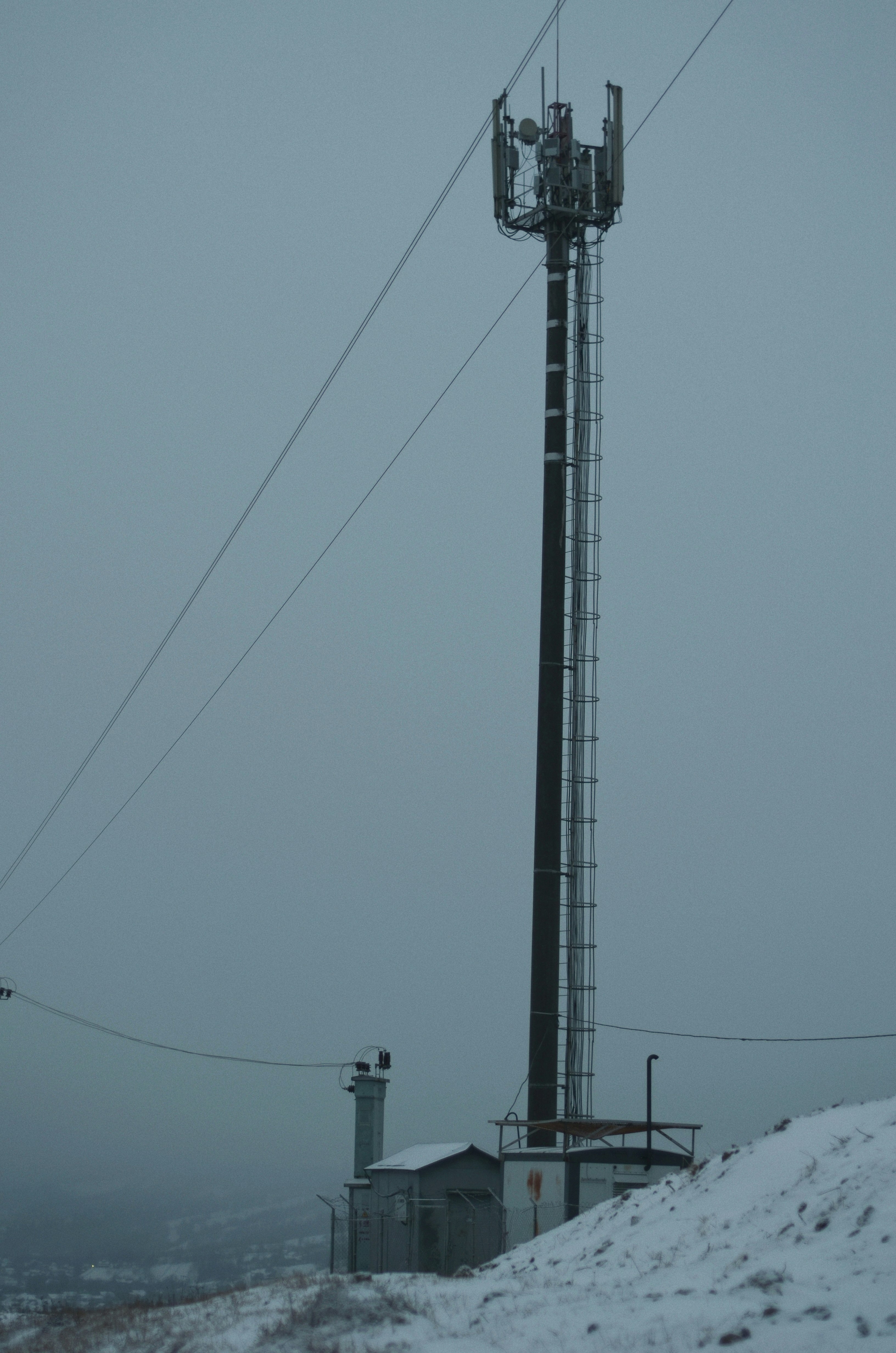 black electric post under blue sky