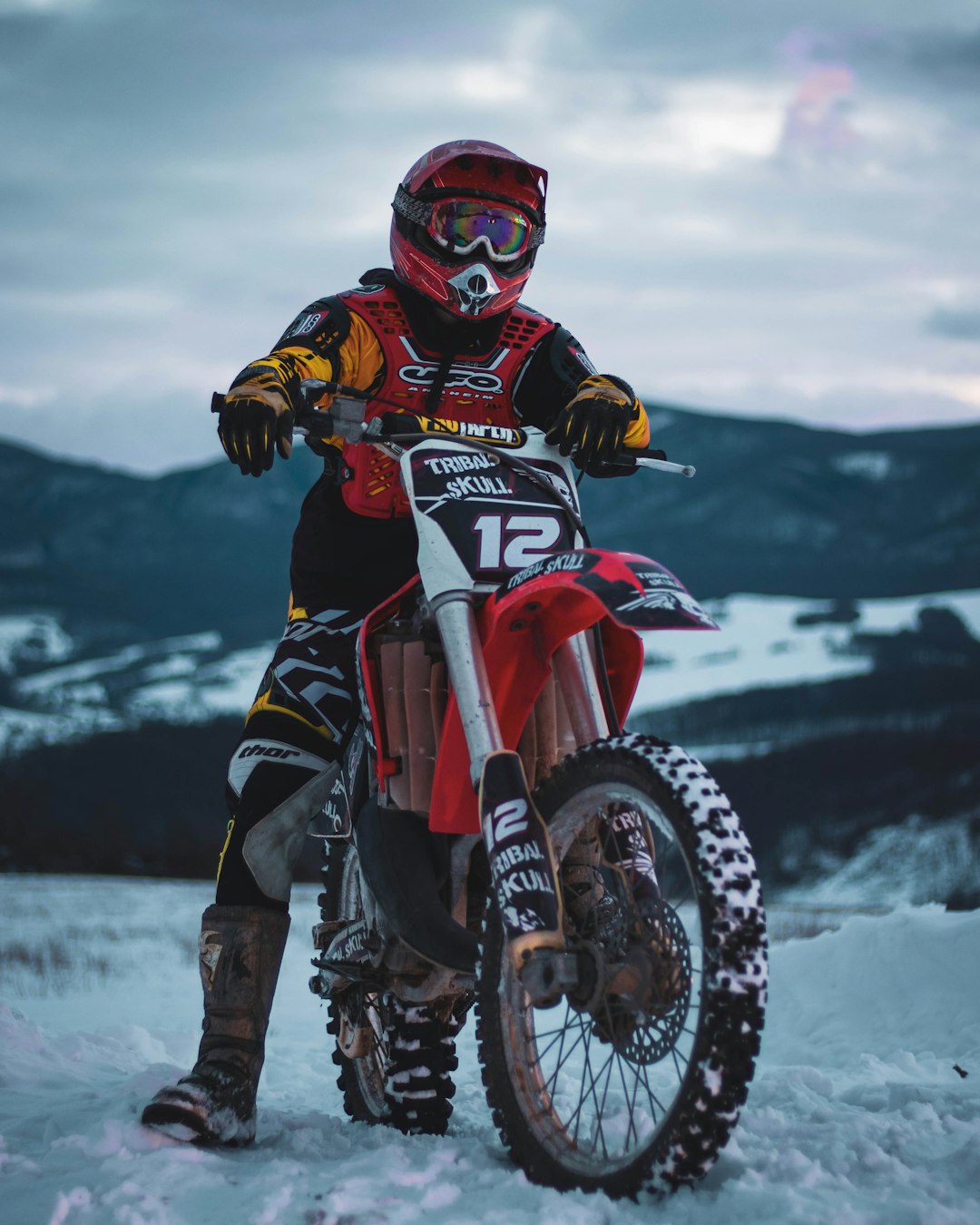 man in red and black motocross helmet riding on red and black motocross dirt bike