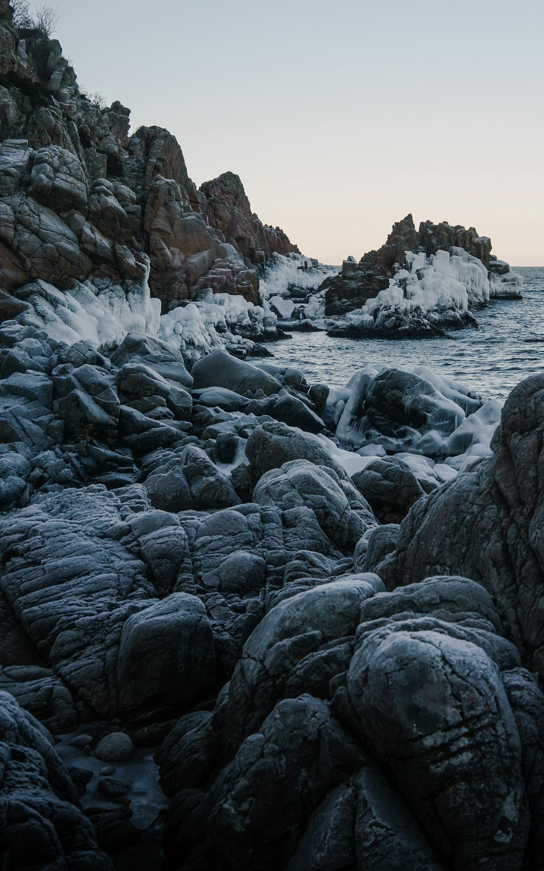 rocky shore with water waves during daytime