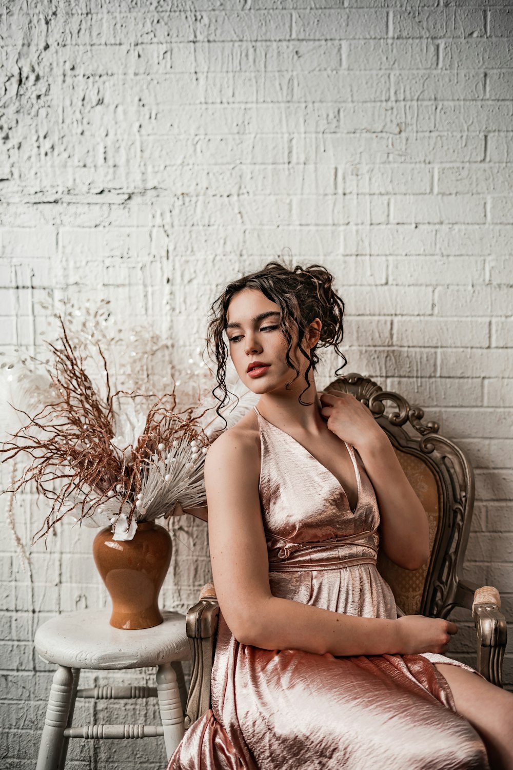 woman in white and brown tube dress sitting on chair