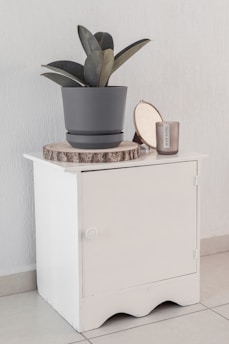 white and brown ceramic mug on white wooden cabinet