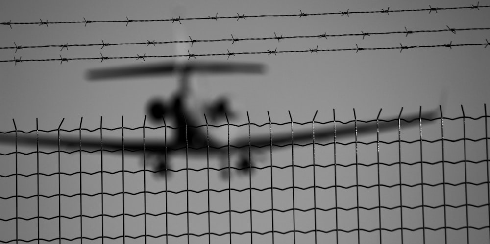 black metal fence in grayscale photography