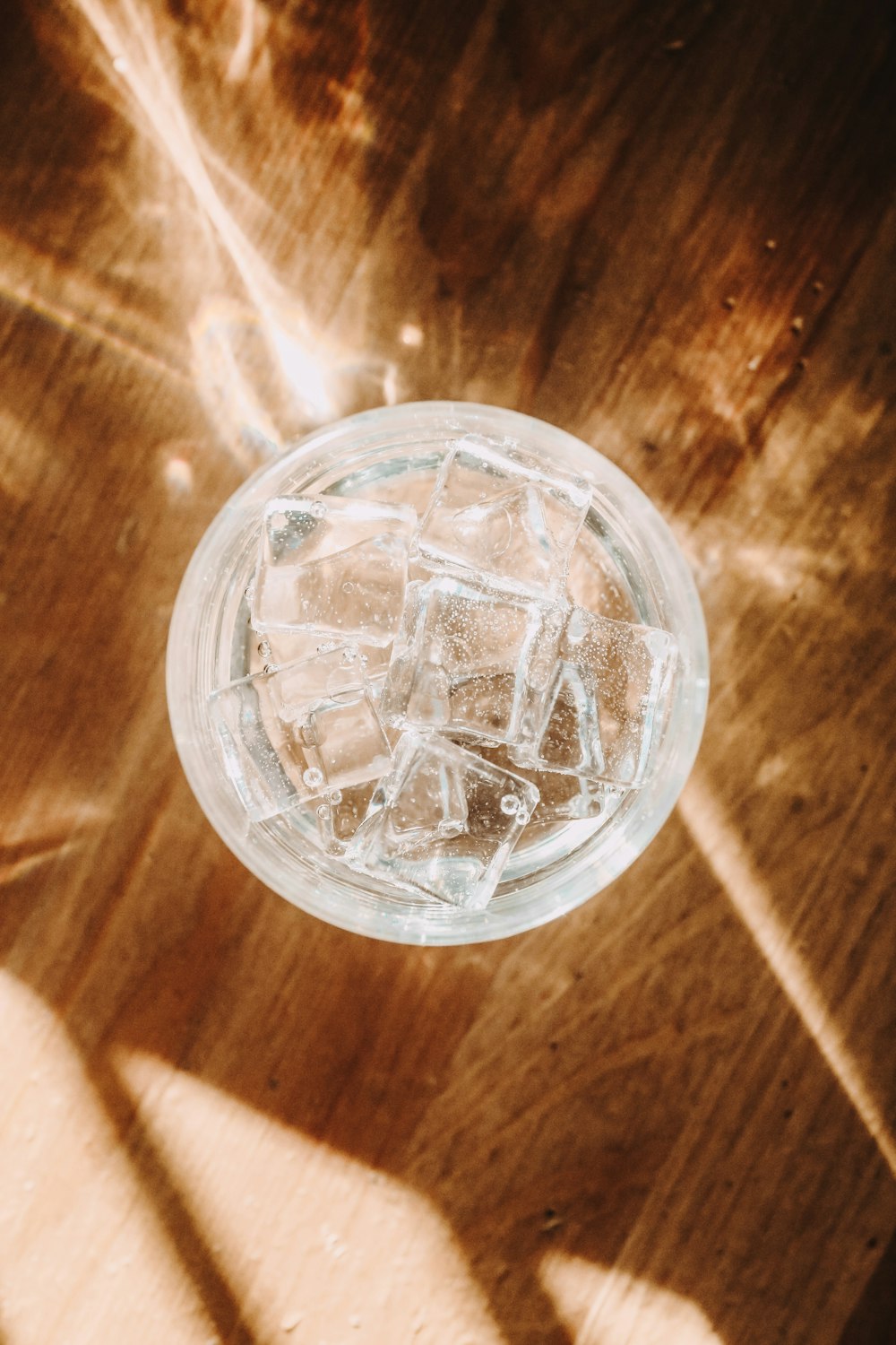 clear glass round bowl on brown wooden table