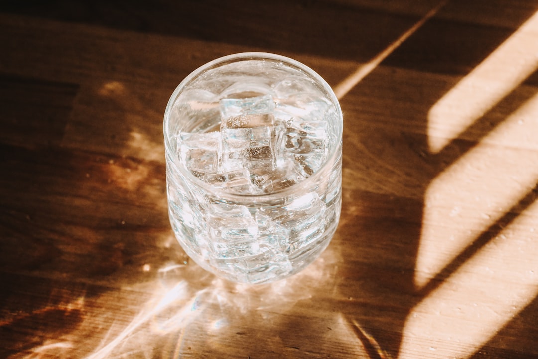 clear glass cup on brown wooden table