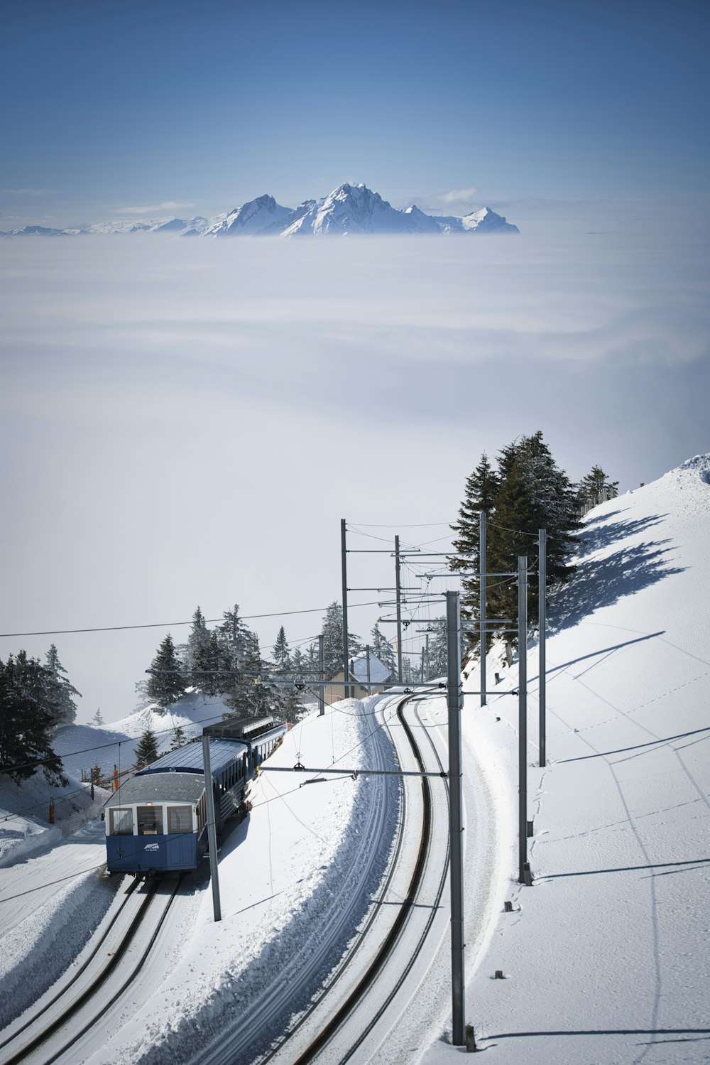 white and black cable car on snow covered ground during daytime