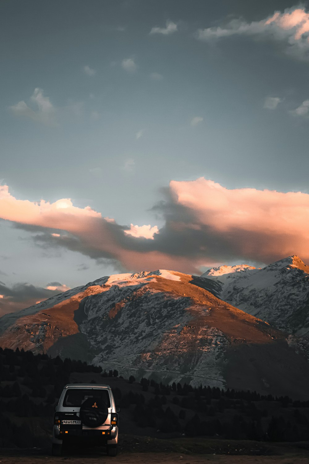 brown and black mountains under white clouds during daytime