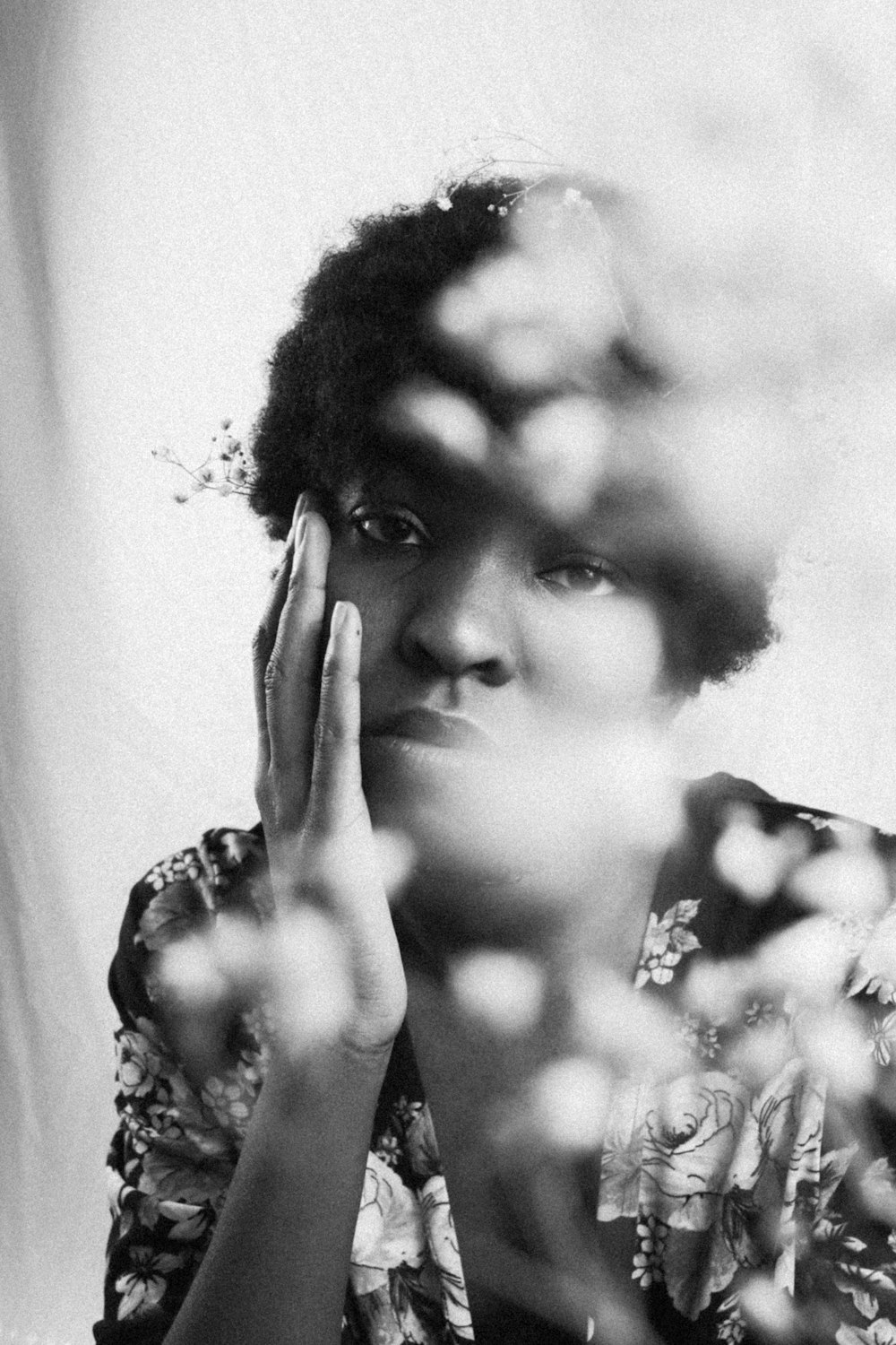 grayscale photo of woman with hand peace sign