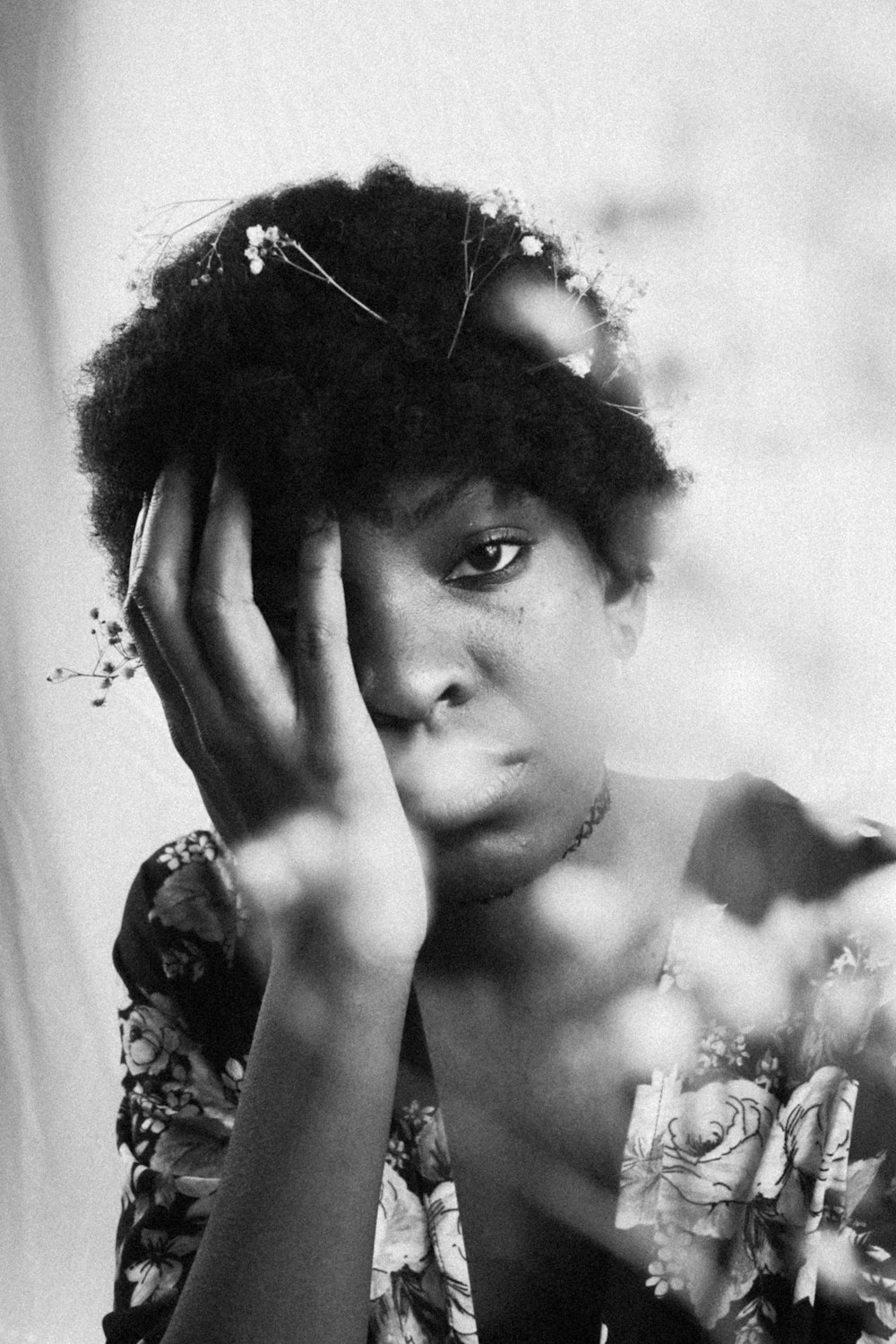 grayscale photo of woman with floral headdress