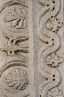 An elegant stone carving with smooth lines and subtle cultural motifs.