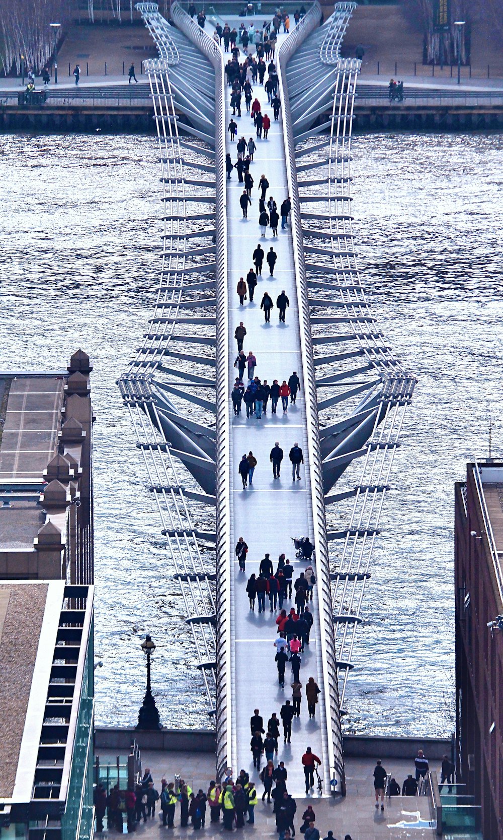 people walking on gray concrete bridge during daytime