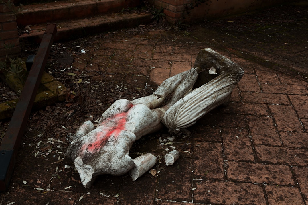 gray concrete statue on brown concrete floor