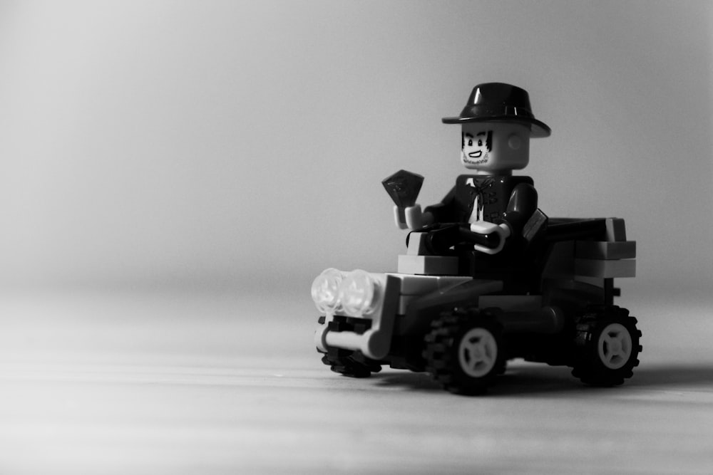 grayscale photo of man riding atv