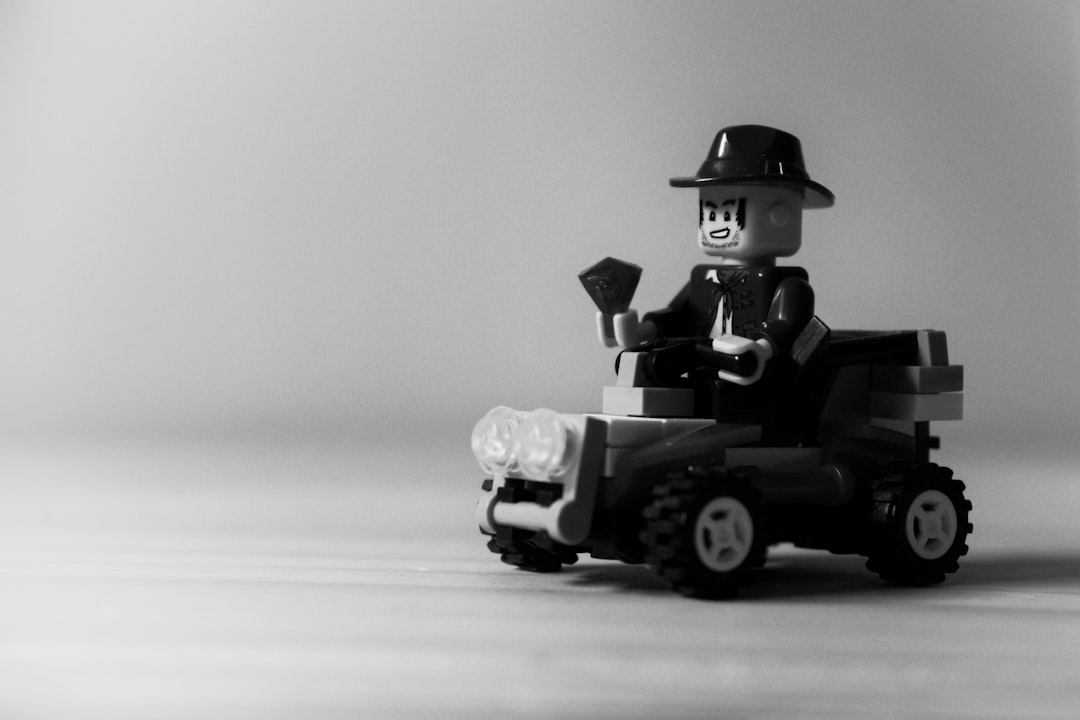 grayscale photo of man riding atv,