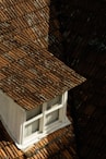 brown roof near white wooden window