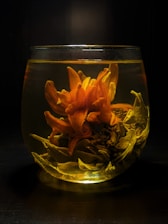 yellow flowers in clear glass vase