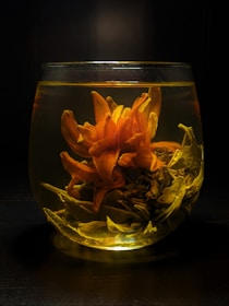 yellow flowers in clear glass vase