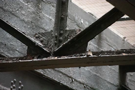 Close-up of a worker applying a rust-resistant coating on a steel beam