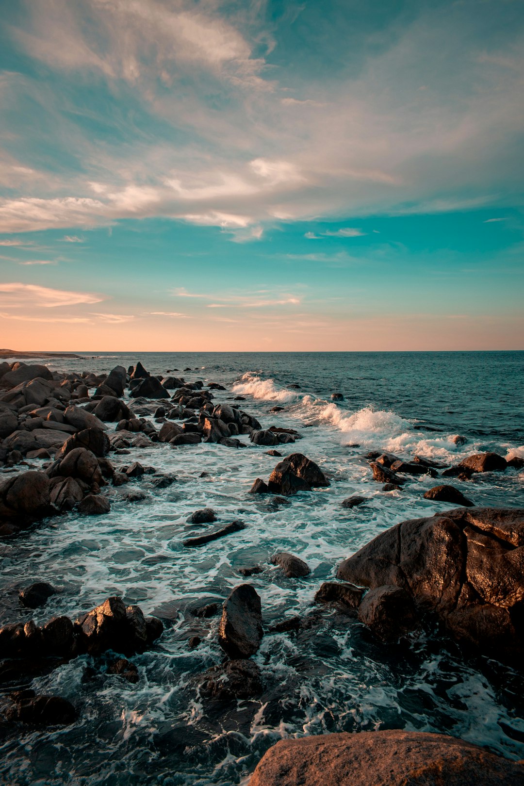 rocky shore under blue sky during daytime