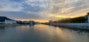 The calm waters of the Ubangi River flowing gently beside the city of Bangui at sunset.
