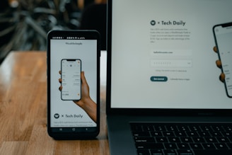 Close-up of a smartphone and laptop showing automated order and delivery tracking interfaces.