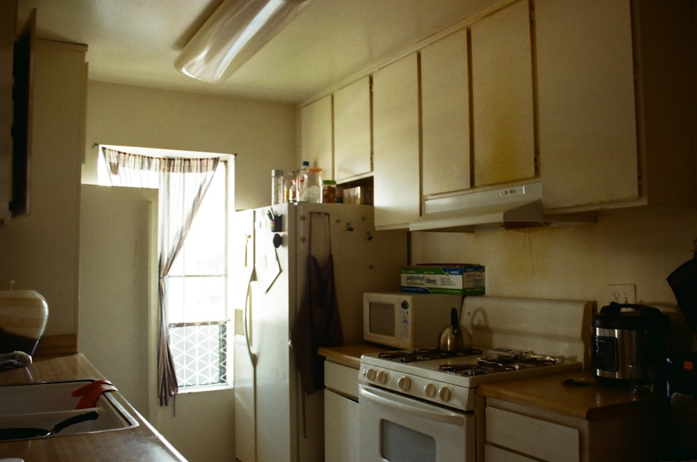 white wooden kitchen cabinet near white wooden door