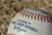 Close-up of a signed baseball card with a vibrant autograph on display.