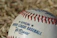 Close-up of a signed baseball card with a vibrant autograph on display.