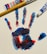 A colorful handprint created with red, blue, and hints of black paint is displayed on a white canvas. Beside the handprint are a wooden-handled paintbrush and tubes of red and blue acrylic paint.