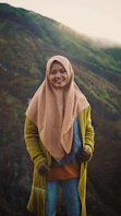 woman in brown hijab and green long sleeve shirt