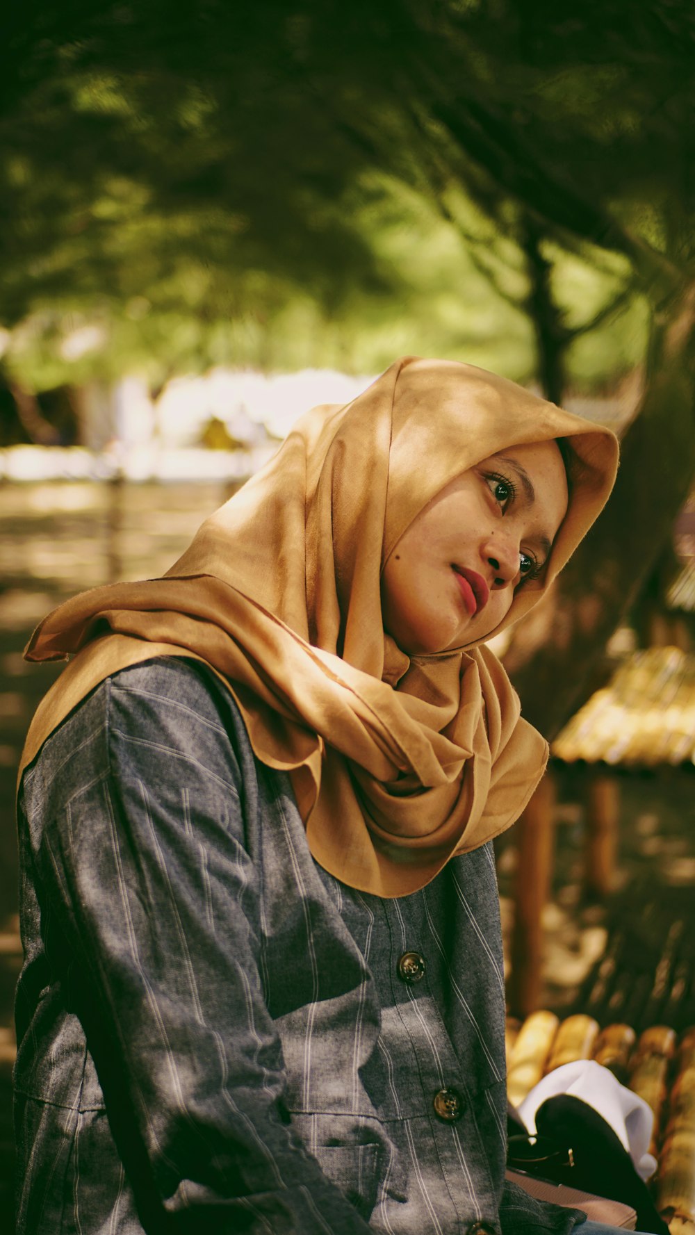 woman in brown hijab and blue denim jacket