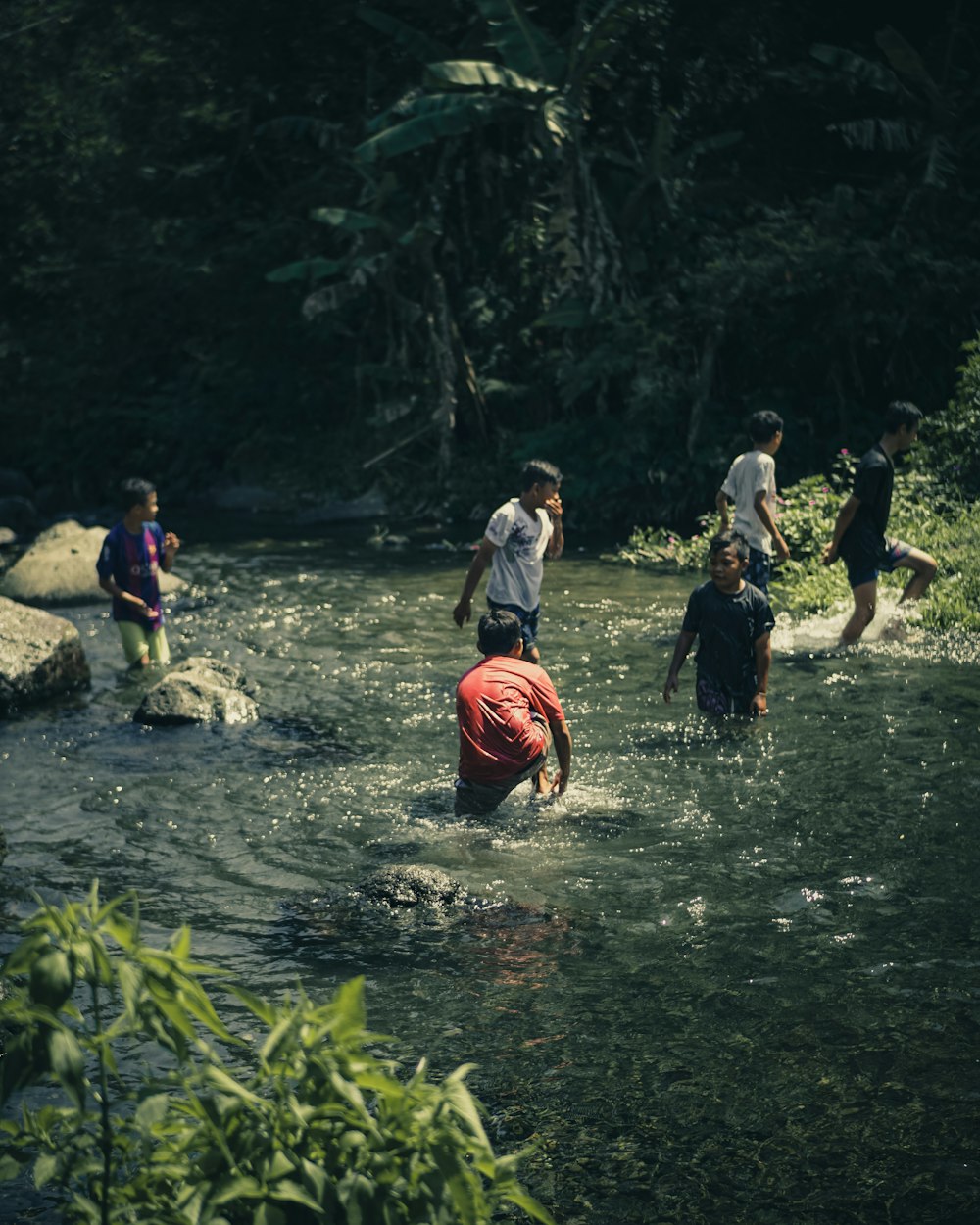 people standing on river during daytime