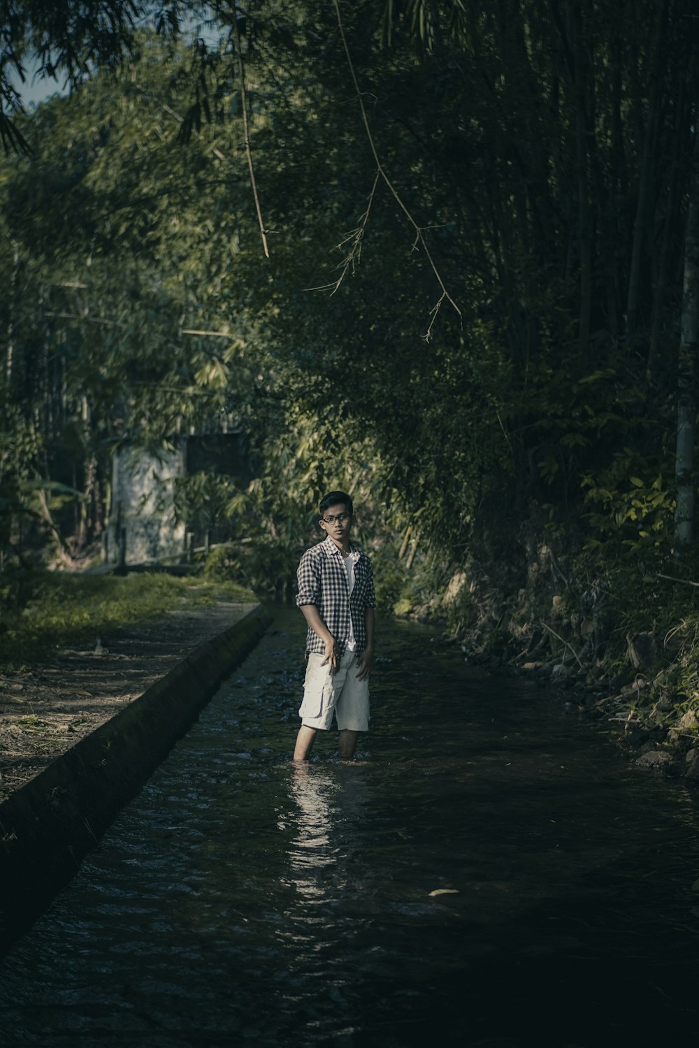 woman in white and black dress standing on wooden bridge