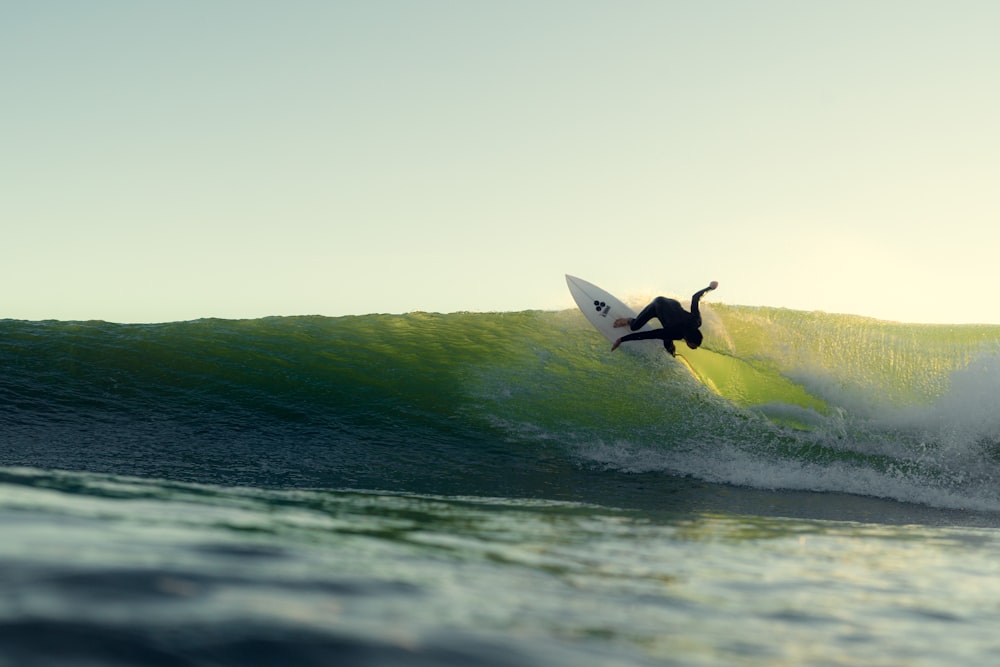 person surfing on sea waves during daytime