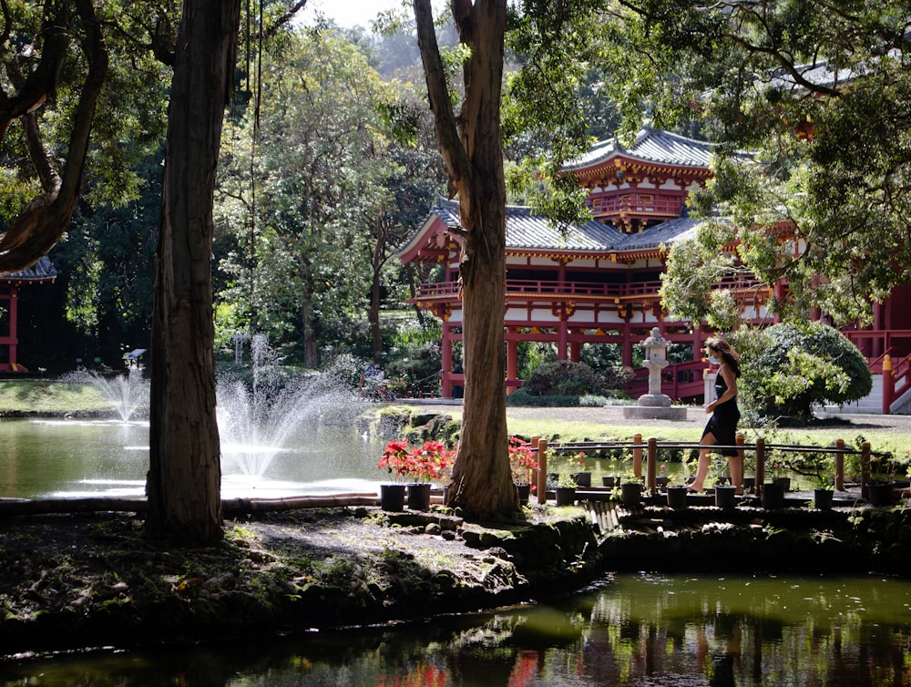 people walking on park near water fountain during daytime