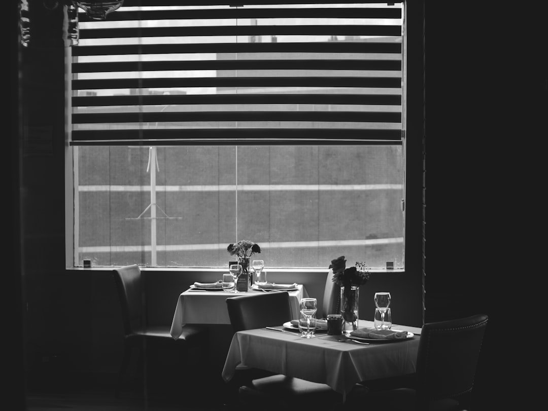 dining table and chairs in grayscale photography