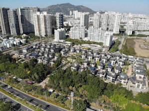 A vibrant aerial view of a bustling Kigali neighborhood with various residential buildings.