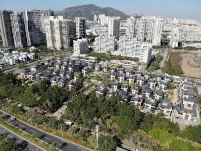 A vibrant aerial view of a bustling Kigali neighborhood with various residential buildings.