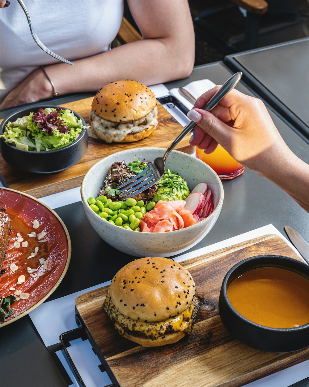 person holding chopsticks and bowl of soup