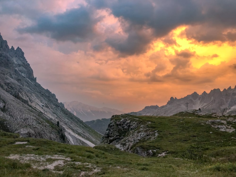 gray and green mountains under cloudy sky during daytime