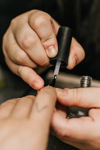 person holding black and silver hand tool