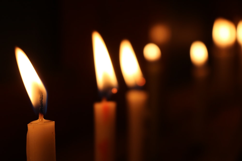 white candles on black background