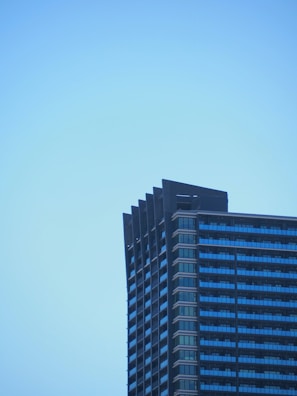 Finished modern building standing tall against a clear sky.