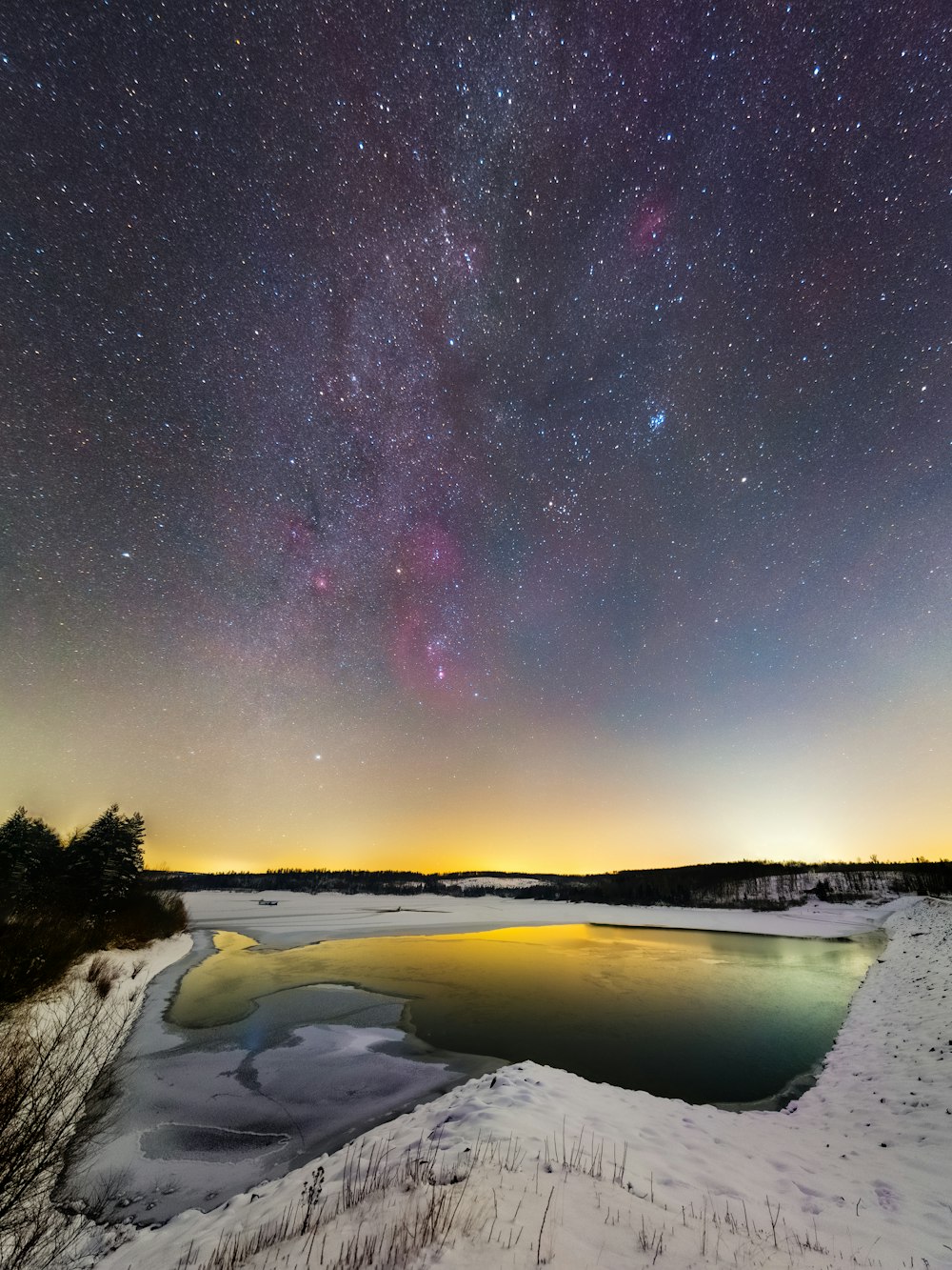 snow covered field under starry night