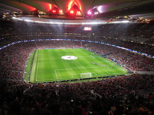 A vibrant photo capturing a lively corporate sports event with teams mid-action on the field.