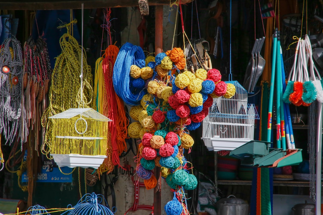 red blue and yellow knit textile on brown wooden hanging rack