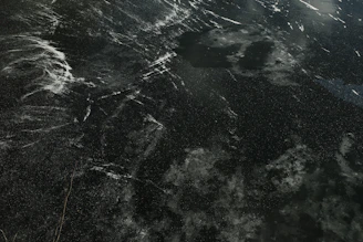 Galaxy quartz slab showcasing deep black tones with scattered white speckles and veins.